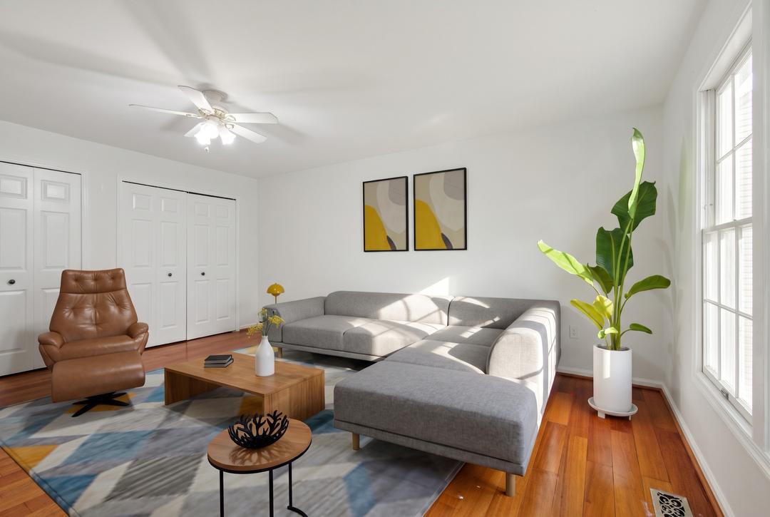 The same staged living room seen from the window side — identical furniture, new angle